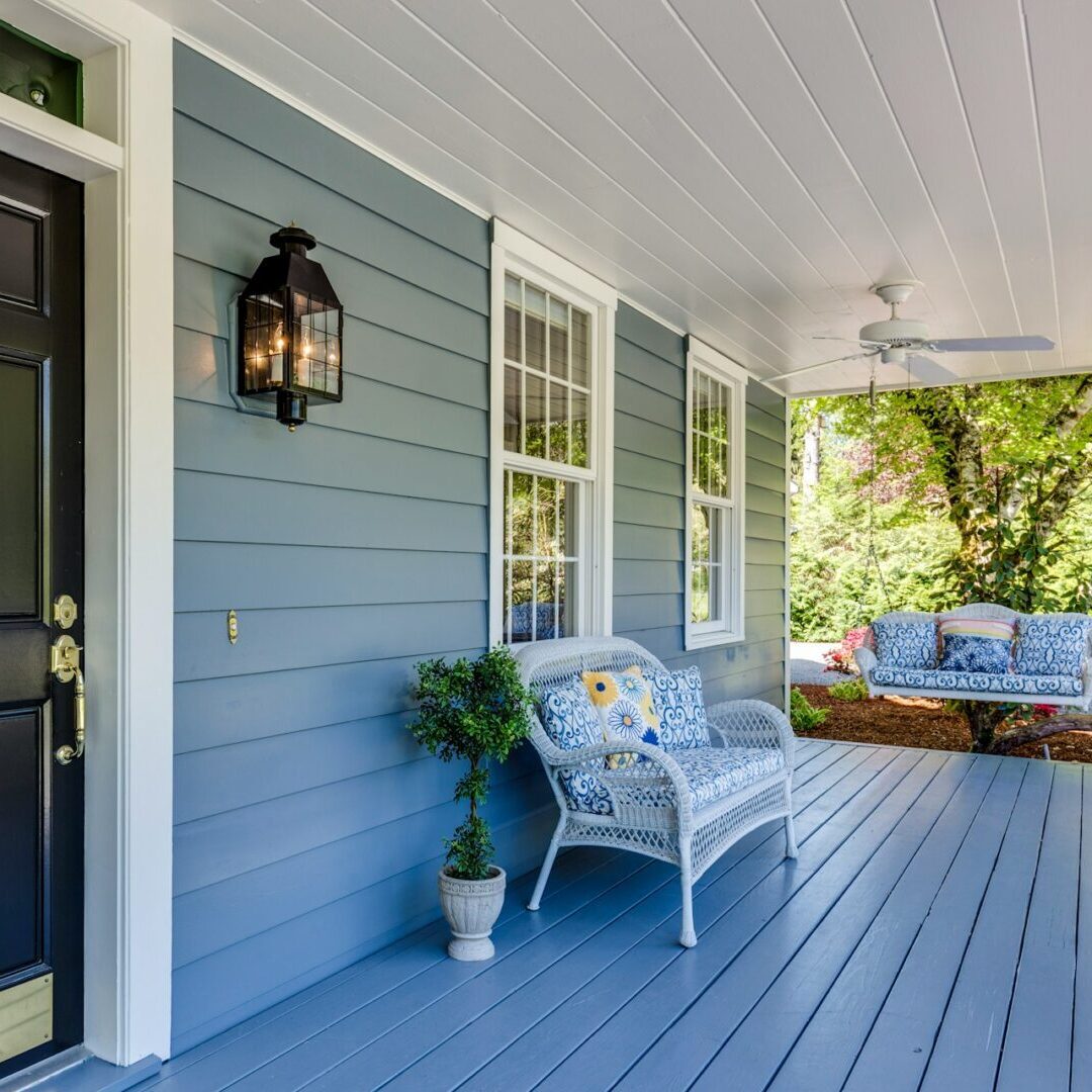 Blue vinyl siding on front porch.