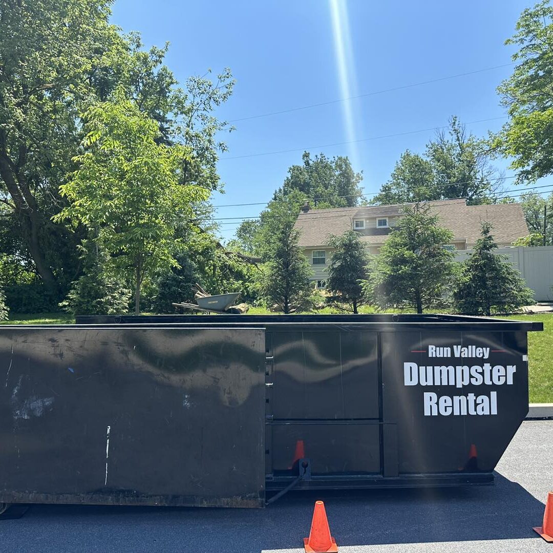 Black dumpster with white lettering.